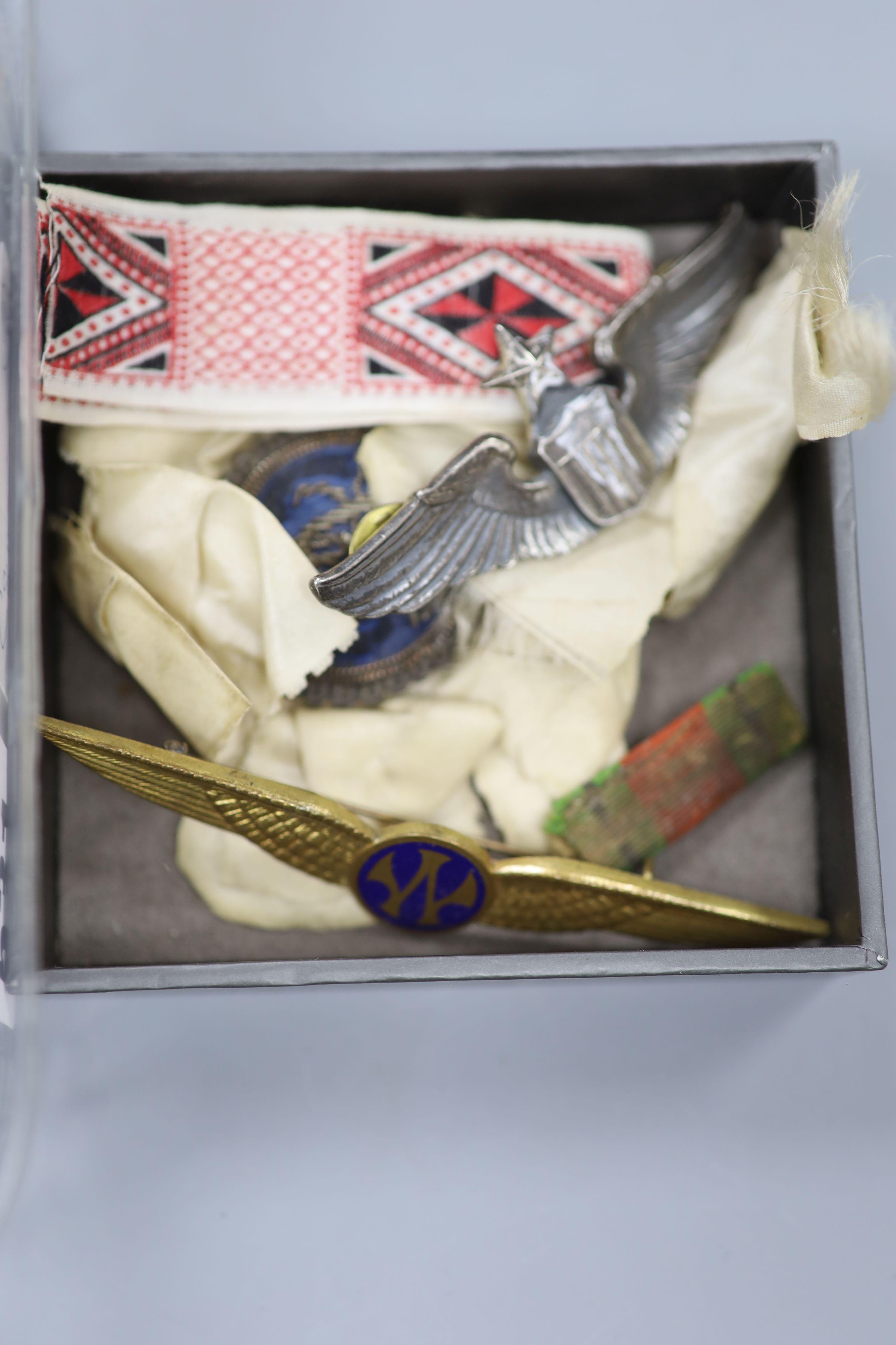 A collection of military medals, badges, coins etc.